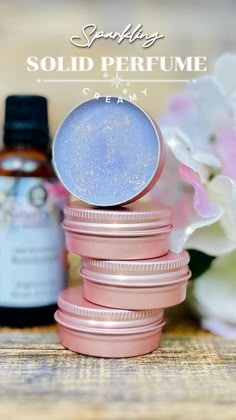 some pink and blue jars with flowers in the background