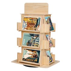 a wooden book stand with four books on it's sides and three magazines in the middle