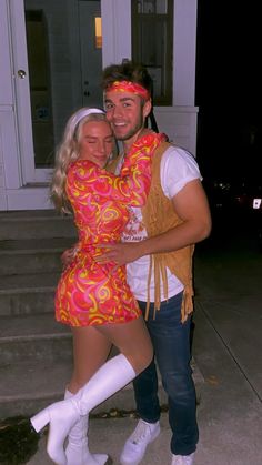 a man and woman dressed in costumes hugging each other