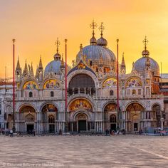 an ornate building with many spires in front of it at sunset or sunrise time