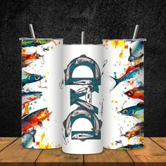 two canisters with different types of fish on them, one is blue and the other is white