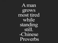 a man grows most tired while standing still chinese prove on black background with white lettering