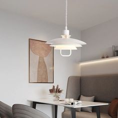 a dining room table with chairs and a lamp hanging from the ceiling over it's head