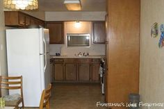 an open kitchen and dining room with wood cabinets