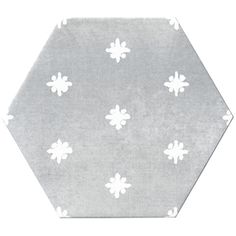 a hexagonal tile with white flowers on grey and white background, in the shape of an octagon