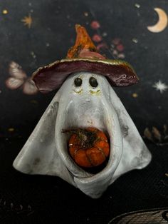 a halloween decoration with a pumpkin in the shape of a ghost