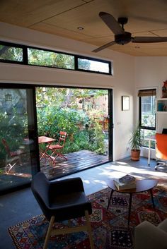 a living room filled with furniture and lots of windows