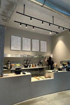 a coffee shop with menus hanging from the ceiling