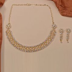 Gold Rodium Polish White and Off White color Necklace in Brass studded with Beads, Cubic Zirconia, CZ Diamond Luxury 22k Gold White Kundan Necklace, Color Necklace, Metal Necklace, White Necklace, Diamond Gold, Cz Diamond, Off White Color, Metal Necklaces, Brass Metal