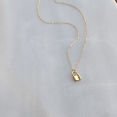 "Tiny Lock Necklace DETAILS -Tiny Lock charm approx. 7mm -Lock is gold plated or silver plated -A high quality delicate link chain with a spring clasp -Chain is 14kt gold filled or sterling silver LENGTH -Measures 16 inches with a 1 1/2 inch extender for a total length of 17 1/2 inches. -You can wear this at 16 inches or 17 1/2 inches. -Also available in 16, 18 or 20 inches with no extender. -Model is wearing 16\" in photos. ∙ EXTRA LOVE ∙ Crafted and curated just for you in the desert of our Ar Minimalist Everyday Jewelry With Lock Detail, Gold Chain Necklace With Lock For Gift, Everyday Silver Necklace With Lock Detail, Minimalist Jewelry With Lock As A Gift, Minimalist Lock Jewelry For Gifts, Minimalist Lock Jewelry As Gift, Minimalist Lock Jewelry As A Gift, Everyday Gold Lock Jewelry, Everyday Gold Jewelry With Lock Detail