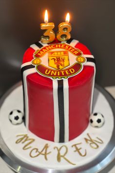 the birthday cake is decorated with an image of manchester united's crest and numbers