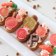 some cookies are decorated with different types of candy and candies on top of each other