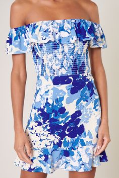 Cool like the sea, this blue abstract floral print embodies the perfect top for a warm day out to brunch. It features an off the shoulder design with a ruffle detail that sweeps from shoulder to shoulder. The bodice is fully smocked to create a flattering fit that ends right at the hips. Wear it with bottoms of your choice or complete the coord set with the matching skirt.- Smocked- Off the shoulder- Ruffle detail- Color: White BlueSize + Fit - Model is 5'9" and wearing size XS- Measurements tak Spring Beach Off-shoulder Smocked Top, Chic Beach Smocked Top With Floral Print, Summer Floral Print Smocked Top For Brunch, Blue Ruched Smocked Top For Spring, Chic Blue Smocked Top For Vacation, Blue Ruffled Smocked Top For Summer, Blue Summer Smocked Top With Ruffles, Blue Smocked Top For Summer Brunch, Blue Smocked Summer Top With Ruffles