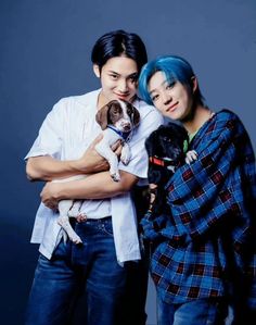 two people with blue hair and one holding a dog