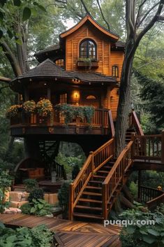 a tree house in the woods with stairs leading up to it's second story