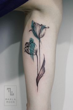 a woman's leg with a flower tattoo on it