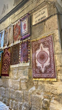 many rugs are hung up on the wall