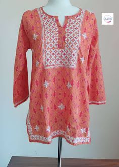 Introducing  short kurta  which looks too pretty.  The soft Cotton fabric ensures that you stay comfortable for long hours and give Sunny Look. Pair this jeans, leggings, pants with a pair of stylish heels and a matching clutch for a complete casual look for a casual event, a party or an evening with friends. TOP Fabric - cotton top Sleeve Type: long Sleeve Neck Type: Round Neck Size - Size Available - 38- 44 inch size is measured is Bust size. Bust Sizes: M (Bust Size: 38 in)  L (Bust Size: 40 Spring Orange Cotton Kurta, Casual Blouse With Chikankari Embroidery For Festive Occasions, Casual Festive Blouse With Chikankari Embroidery, Festival Straight Kurta Top With Dabka Work, Casual Tops With Resham Embroidery For Festive Season, Spring Tunic Top With Intricate Embroidery, Orange Long Sleeve Blouse With Floral Embroidery, Pink Long Sleeve Tops For Eid, Long Sleeve Pink Top For Eid