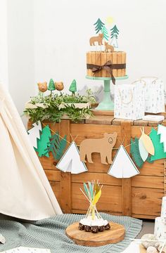 a wooden chest with decorations on it and a teepee tent in the corner next to it