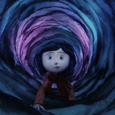 a doll is sitting in the middle of a blue and purple tunnel with an evil look on its face