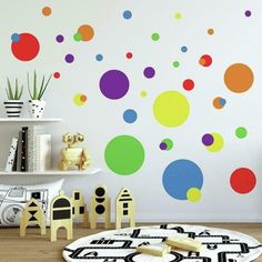 colorful polka dot wall decals in a child's room with toys on the floor