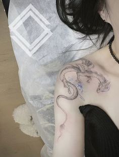 a woman with a dragon tattoo on her shoulder