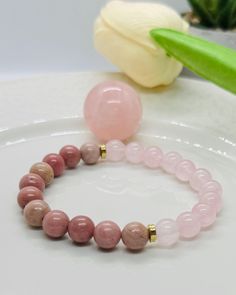 The crystal of unconditional love, self love, forgiveness and reconciliation. Rose Quartz opens the heart chakra and encourages harmony and trust. By balancing your emotions, Rhodonite grounds your heart chakra and helps you express your love.  It teaches us to be present, and avoid getting stuck in the past, or focusing on revenge. Healing Gemstone Rosary Bracelet, Spiritual Rose Quartz Crystal Bracelet With 8mm Beads, Spiritual Rose Quartz Bracelet With 8mm Beads, Rose Quartz Beaded Bracelets For Meditation, Hand-strung Rose Quartz Crystal Bracelet For Healing, Rose Quartz Beaded Bracelets For Healing, Healing Rose Quartz Beaded Bracelets, Holistic Crystal Bracelet With Round Beads As Gift, Spiritual Rose Quartz Crystal Bracelet For Healing