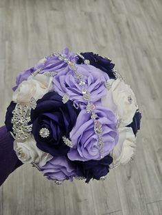 a bridal bouquet with purple and white flowers