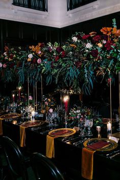 an image of a table setting with candles and flowers on it for a wedding reception