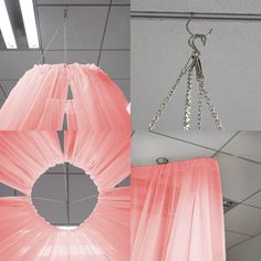 a pink lamp shade hanging from a ceiling