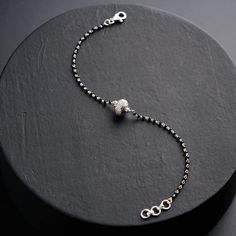 Modern Minimalism: Features black spinel beads paired with a sleek silver bead for a simple yet stylish look. High-Quality Silver: Made from 92.5% certified, handcrafted silver. Everyday Elegance: A subtle design perfect for daily wear. Comfortable Fit: Adjustable 7-inch length with a secure clasp. Handmade Craftsmanship: Lovingly crafted by Indian artisans. Lightweight & Durable: Built for long-lasting use. Versatile Styling: Complements both casual and ethnic outfits. Thoughtful Gift: A meanin Small Earrings Gold, Black Beads Mangalsutra, Everyday Elegance, Ethnic Outfits, Black Spinel