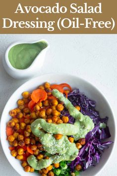 a white bowl filled with salad and dressing next to a small spoon on the side