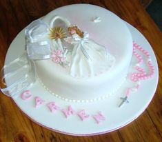 a white cake with pink decorations on it