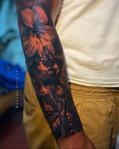 a man with a flower tattoo on his arm