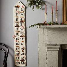 a wall hanging with numbers on it next to a fire place and a fireplace mantel