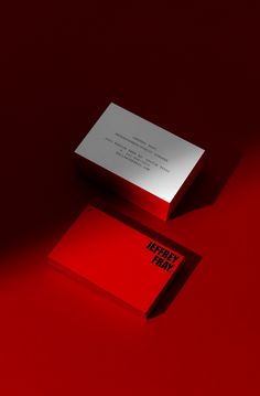 a red business card sitting on top of a table