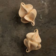 three uncooked pasta shells sitting on top of a table