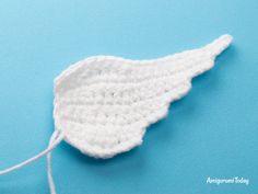 a white crocheted object on a blue surface