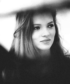 a black and white photo of a woman with long hair