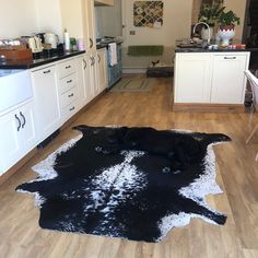 a black and white cow skin rug in a kitchen