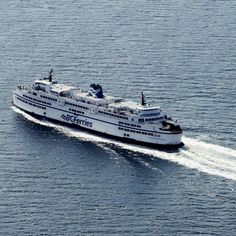 a large white boat traveling across a body of water on top of a blue ocean