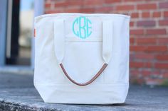 a canvas tote bag with a monogrammed initials on the front