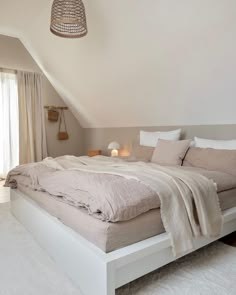 a large bed sitting in the middle of a bedroom