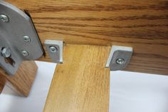 a close up view of a wooden table with metal brackets