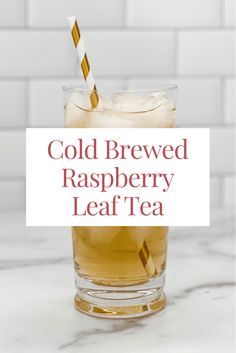 cold iced raspberry leaf tea in a glass with a straw on the top