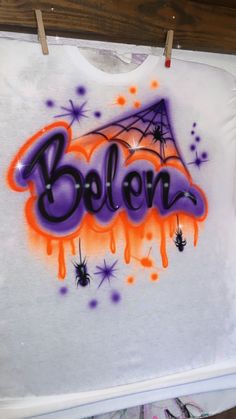 a t - shirt with the word bolern painted on it and spider webs