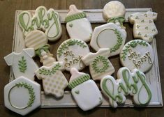 decorated cookies in the shape of baby's first and second names on a tray