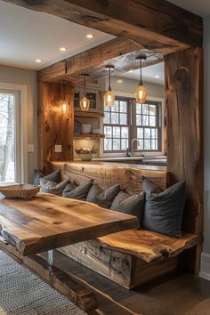 a wooden table sitting in the middle of a living room next to a kitchen area