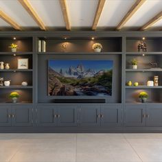 an entertainment center with built - in shelving units and a flat screen tv mounted on the wall