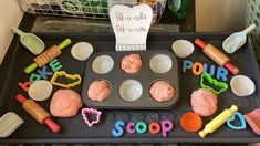 a tray with cupcakes and baking utensils on it